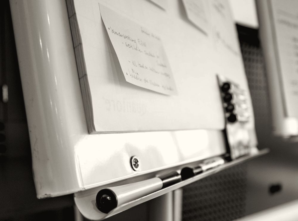 A flipchart with sticky notes, set up for a workshop